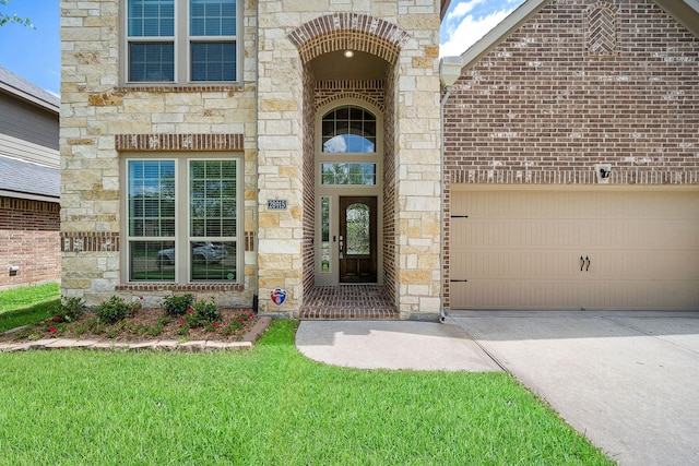 28915 Crested Butte Dr, Katy, TX 77494 - doorway to property featuring stone siding, driveway, and an attached garage