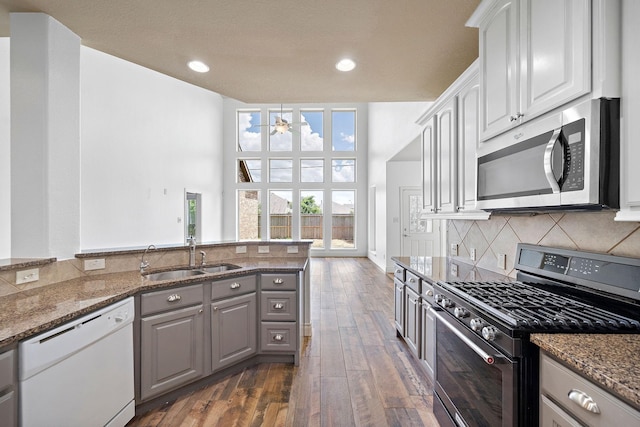 28915 Crested Butte Dr, Katy, TX 77494 - kitchen featuring range with gas cooktop, stainless steel microwave, white dishwasher, ceiling fan, and gray cabinets