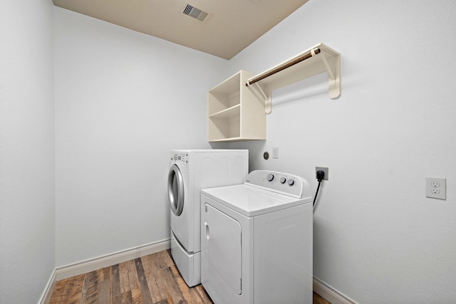 28915 Crested Butte Dr, Katy, TX 77494 - laundry room featuring washer and dryer and wood finished floors