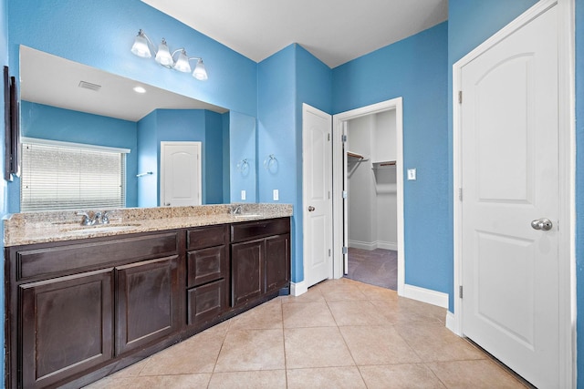 28915 Crested Butte Dr, Katy, TX 77494 - bathroom featuring double vanity, a spacious closet, and tile patterned flooring