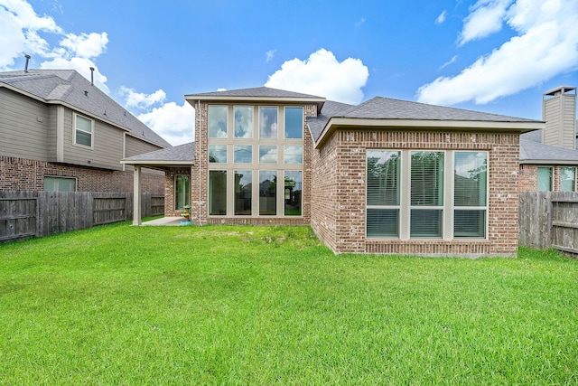 28915 Crested Butte Dr, Katy, TX 77494 - back of house featuring a fenced backyard, brick siding, and a shingled roof
