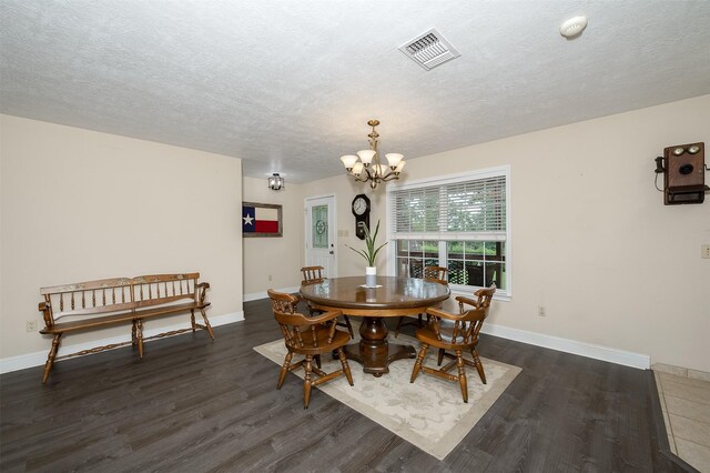 505 Sage Brush Dr, Somerville, TX 77879 - dining area featuring a chandelier, dark wood-style flooring, and a textured ceiling