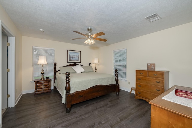 505 Sage Brush Dr, Somerville, TX 77879 - bedroom with dark wood-style flooring, a textured ceiling, and a ceiling fan