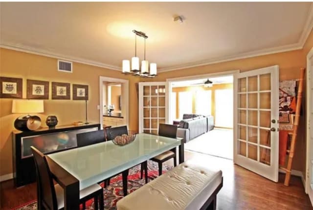 1216 S Shepherd Dr, Houston, TX 77019 - dining area featuring french doors, crown molding, a chandelier, and wood finished floors