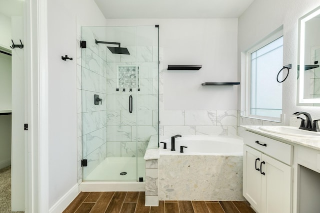 133 Water Grass Trl, Clute, TX 77531 - full bathroom with a shower stall, a bath, wood finished floors, and vanity