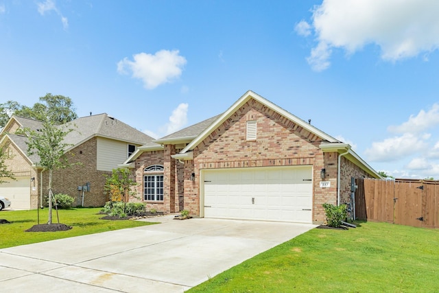 133 Water Grass Trl, Clute, TX 77531 - view of front facade featuring brick siding, concrete driveway, and an attached garage