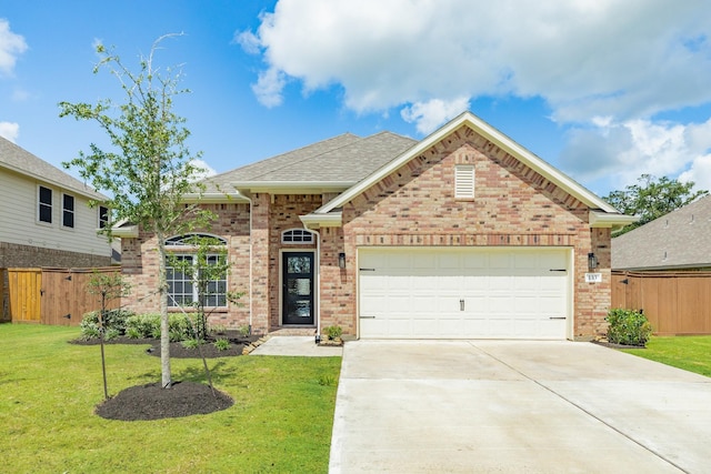 133 Water Grass Trl, Clute, TX 77531 - view of front of property with brick siding, an attached garage, driveway, and a shingled roof