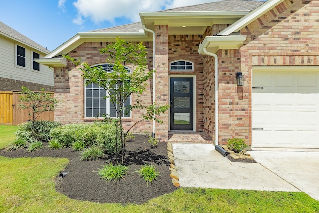 133 Water Grass Trl, Clute, TX 77531 - doorway to property with brick siding, an attached garage, and a shingled roof