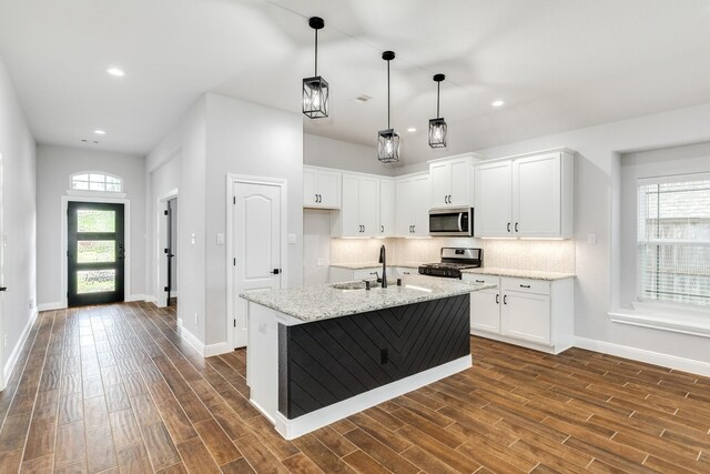 133 Water Grass Trl, Clute, TX 77531 - kitchen featuring stainless steel appliances, dark wood-type flooring, white cabinetry, backsplash, and recessed lighting