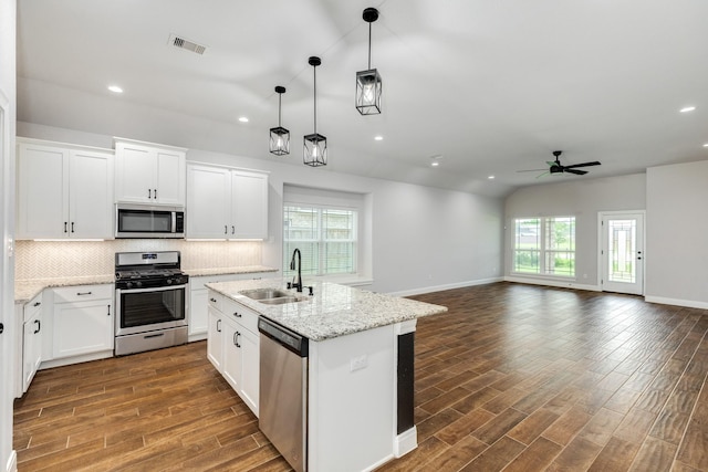 133 Water Grass Trl, Clute, TX 77531 - kitchen featuring stainless steel appliances, ceiling fan, recessed lighting, dark wood-style floors, and backsplash