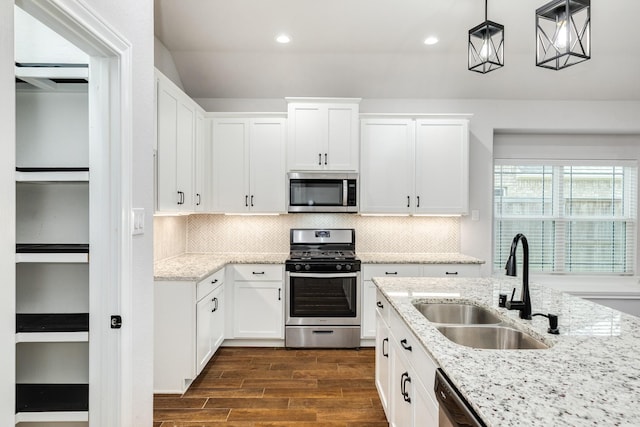133 Water Grass Trl, Clute, TX 77531 - kitchen with stainless steel appliances, dark wood-style flooring, white cabinetry, and recessed lighting