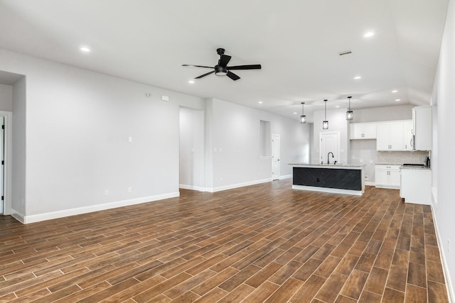 133 Water Grass Trl, Clute, TX 77531 - unfurnished living room with ceiling fan, recessed lighting, and dark wood-type flooring