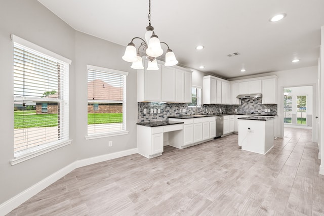 14910 High Meadow Ln, Baytown, TX 77523 - kitchen with tasteful backsplash, stainless steel dishwasher, under cabinet range hood, dark countertops, and recessed lighting