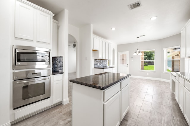 14910 High Meadow Ln, Baytown, TX 77523 - kitchen featuring stainless steel appliances, a ceiling fan, tasteful backsplash, white cabinetry, and recessed lighting