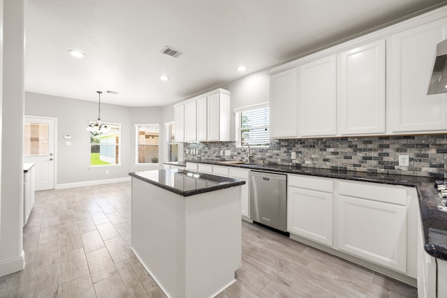 14910 High Meadow Ln, Baytown, TX 77523 - kitchen featuring stainless steel dishwasher, decorative backsplash, white cabinets, a kitchen island, and light wood-style floors