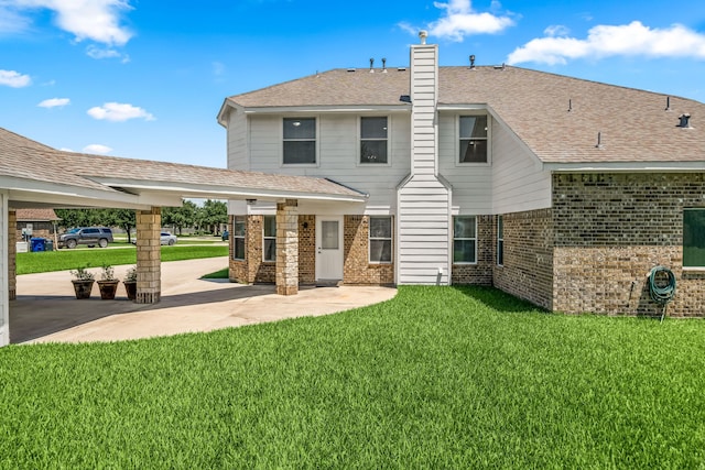 14910 High Meadow Ln, Baytown, TX 77523 - back of property with brick siding, a patio, a chimney, a yard, and a shingled roof