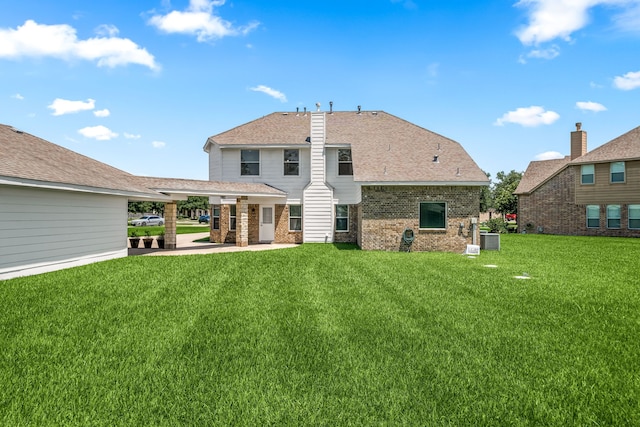 14910 High Meadow Ln, Baytown, TX 77523 - back of property with brick siding, a lawn, a patio area, and roof with shingles
