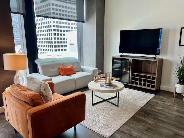 1211 Caroline St Unit 1007, Houston, TX 77002 - living area featuring wood finished floors and baseboards