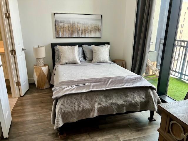 1211 Caroline St Unit 1007, Houston, TX 77002 - bedroom featuring wood finished floors