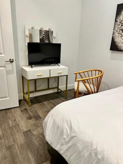 1211 Caroline St Unit 1007, Houston, TX 77002 - bedroom with wood finished floors and baseboards