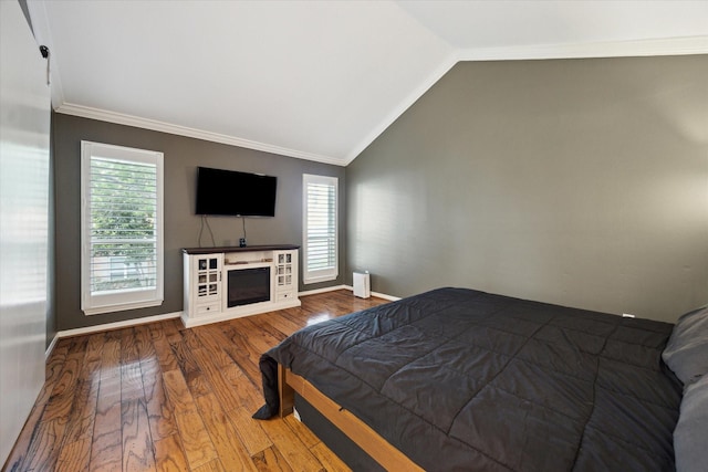 5940 Woodway Place Ct, Houston, TX 77057 - bedroom featuring multiple windows, lofted ceiling, wood finished floors, and ornamental molding