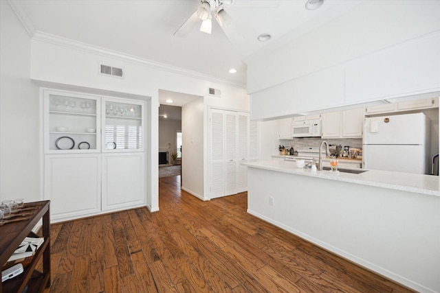 5940 Woodway Place Ct, Houston, TX 77057 - kitchen with white appliances, crown molding, light countertops, ceiling fan, and dark wood-style flooring