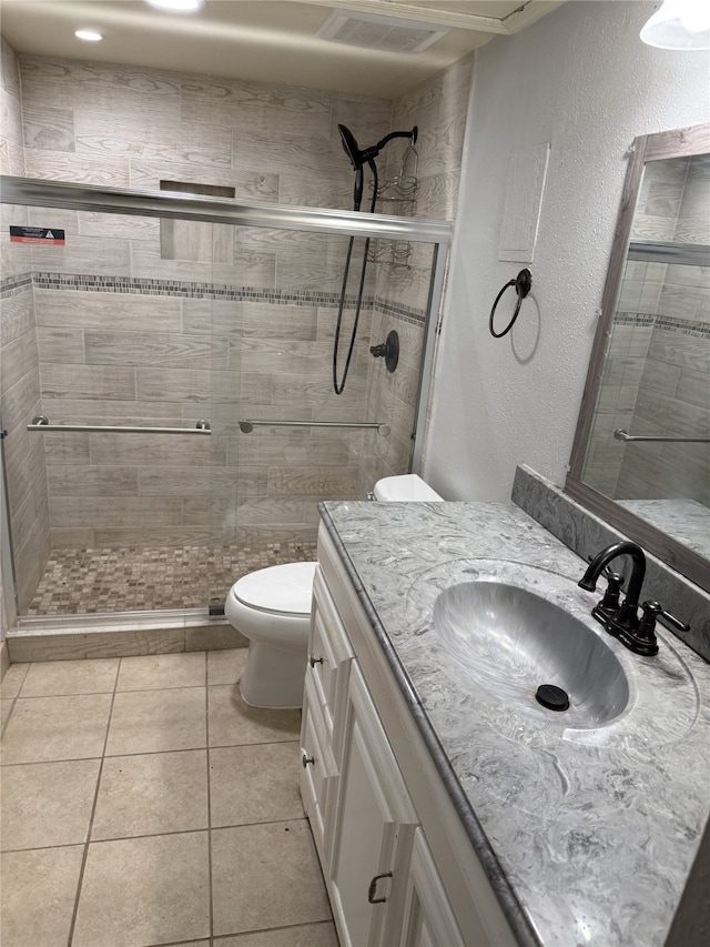 7555 Katy Fwy Unit 57, Houston, TX 77024 - full bath with vanity, a stall shower, a textured wall, and tile patterned flooring