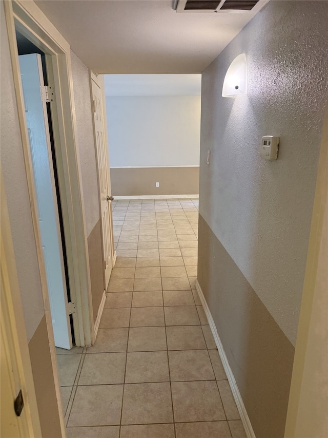7555 Katy Fwy Unit 57, Houston, TX 77024 - hall with light tile patterned floors and a textured wall