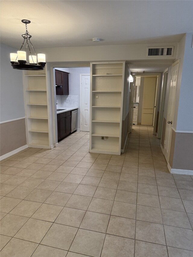 7555 Katy Fwy Unit 57, Houston, TX 77024 - unfurnished room with light tile patterned floors and a chandelier