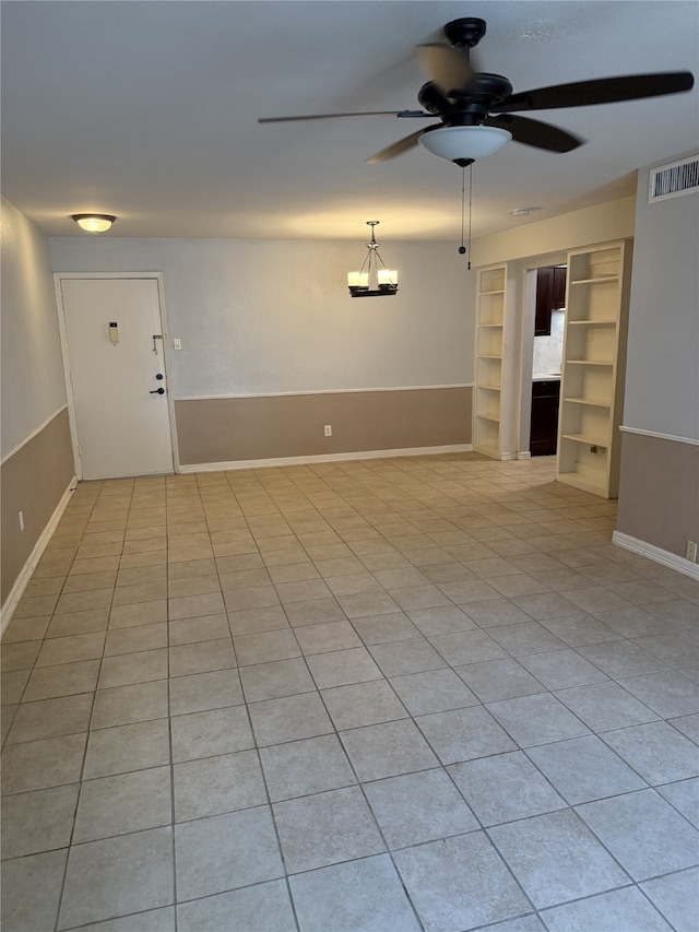 7555 Katy Fwy Unit 57, Houston, TX 77024 - spare room featuring ceiling fan, built in features, and light tile patterned floors