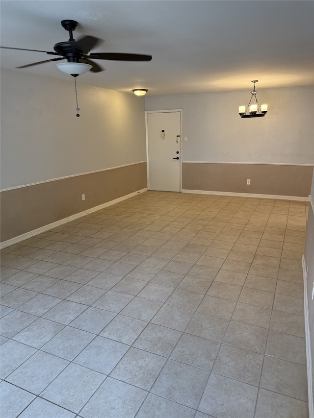 7555 Katy Fwy Unit 57, Houston, TX 77024 - unfurnished room featuring a ceiling fan, light tile patterned flooring, and a chandelier