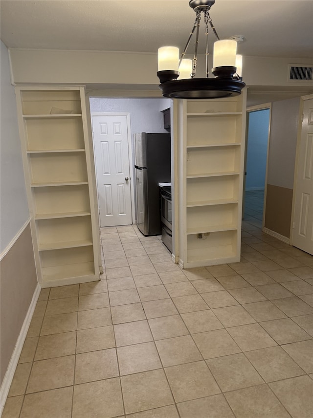 7555 Katy Fwy Unit 57, Houston, TX 77024 - unfurnished dining area featuring light tile patterned floors, built in features, and a chandelier