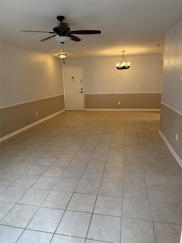 7555 Katy Fwy Unit 57, Houston, TX 77024 - empty room with ceiling fan, a chandelier, and light tile patterned floors