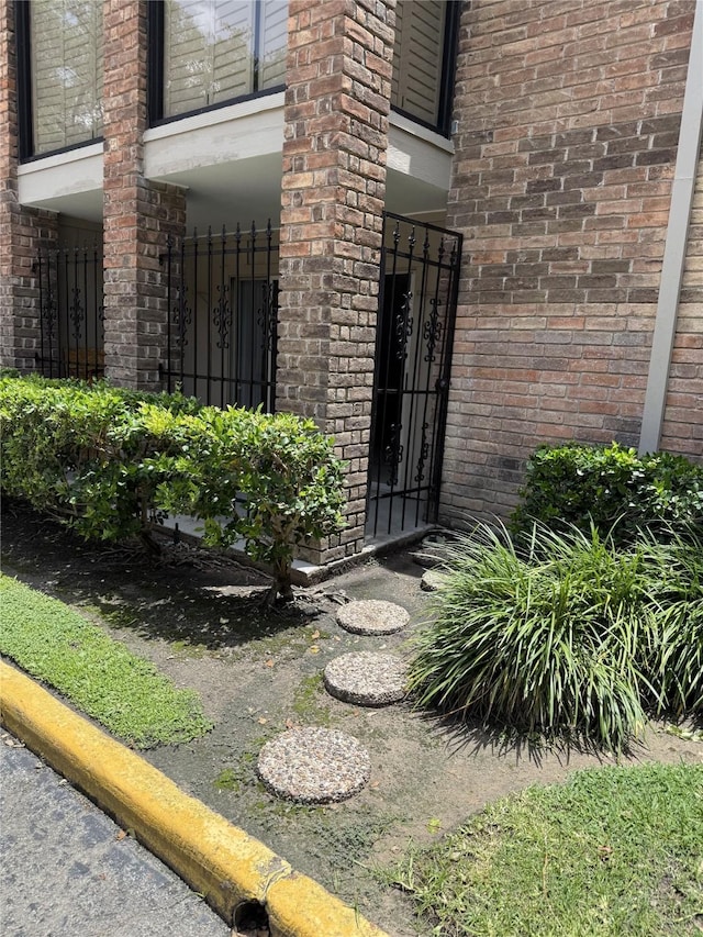 7555 Katy Fwy Unit 57, Houston, TX 77024 - doorway to property with brick siding