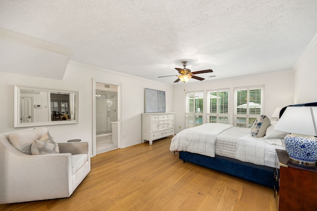 9727 Godstone Ln, Spring, TX 77379 - bedroom with crown molding, a textured ceiling, light wood-style floors, a ceiling fan, and ensuite bath