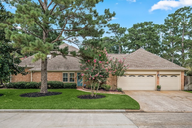 9727 Godstone Ln, Spring, TX 77379 - view of front facade featuring concrete driveway, a front yard, brick siding, and a garage