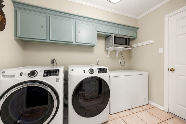 9727 Godstone Ln, Spring, TX 77379 - laundry area with washing machine and clothes dryer, cabinet space, crown molding, and light tile patterned floors