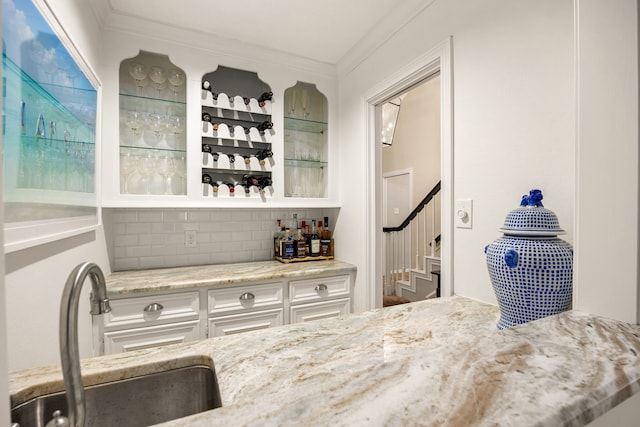 9727 Godstone Ln, Spring, TX 77379 - indoor dry bar featuring stairs, ornamental molding, and backsplash