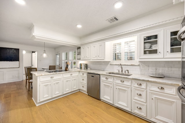 9727 Godstone Ln, Spring, TX 77379 - kitchen featuring dishwasher, a peninsula, white cabinetry, tasteful backsplash, and crown molding