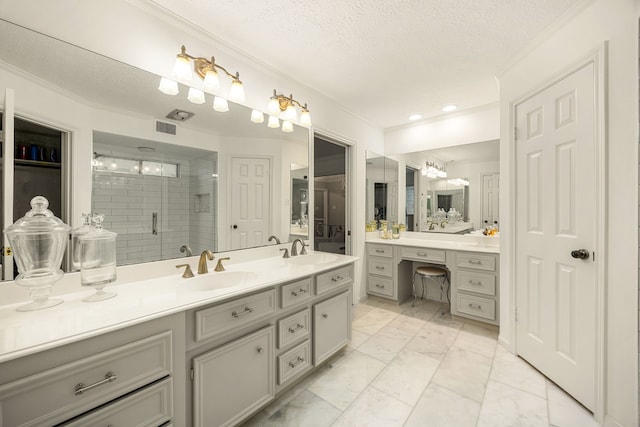 9727 Godstone Ln, Spring, TX 77379 - bathroom featuring vanity, a stall shower, ornamental molding, a textured ceiling, and marble look tile flooring
