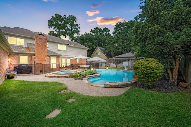 9727 Godstone Ln, Spring, TX 77379 - pool at dusk featuring an in-ground hot tub, a fenced backyard, and a patio area