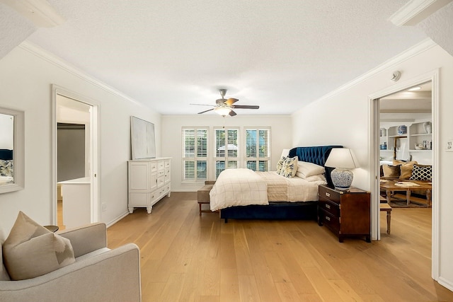 9727 Godstone Ln, Spring, TX 77379 - bedroom featuring a textured ceiling, ornamental molding, light wood-style flooring, and a ceiling fan