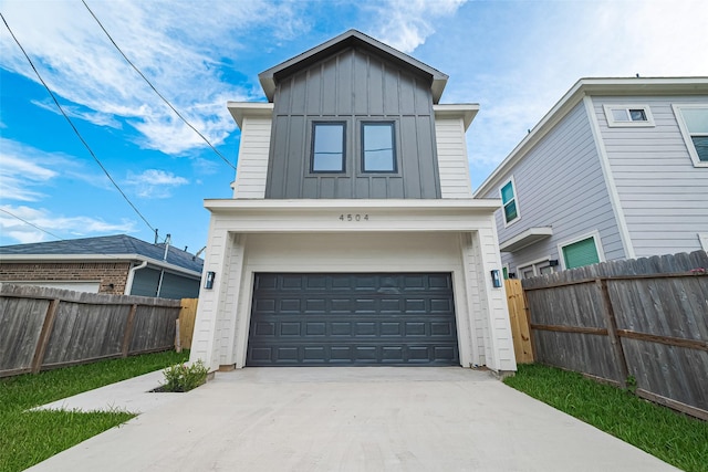 4504 Rosemont St, Houston, TX 77051 - view of front facade with board and batten siding, concrete driveway, and an attached garage