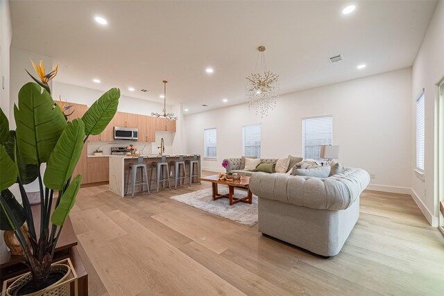 4504 Rosemont St, Houston, TX 77051 - living area featuring a chandelier, light wood-style flooring, and recessed lighting