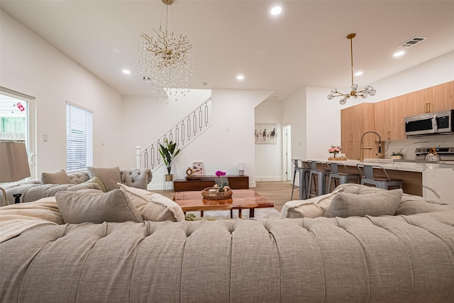 4504 Rosemont St, Houston, TX 77051 - living area with a chandelier, stairway, recessed lighting, and light wood finished floors