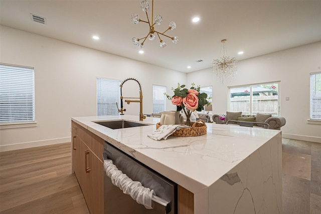 4504 Rosemont St, Houston, TX 77051 - kitchen featuring stainless steel dishwasher, a kitchen island with sink, recessed lighting, light wood-style flooring, and a chandelier
