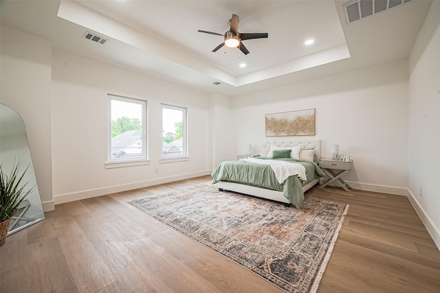 4504 Rosemont St, Houston, TX 77051 - bedroom featuring a tray ceiling, wood finished floors, recessed lighting, and a ceiling fan