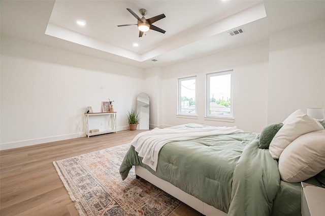 4504 Rosemont St, Houston, TX 77051 - bedroom with a tray ceiling, light wood finished floors, recessed lighting, and ceiling fan