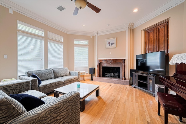 3665 Maranatha Dr, Sugar Land, TX 77479 - living area featuring ornamental molding, a ceiling fan, light wood-style floors, a high end fireplace, and recessed lighting