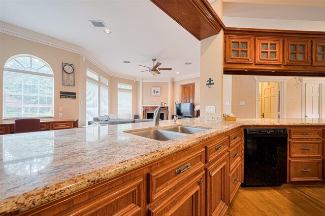 3665 Maranatha Dr, Sugar Land, TX 77479 - kitchen featuring dishwasher, brown cabinets, light wood finished floors, light stone countertops, and crown molding